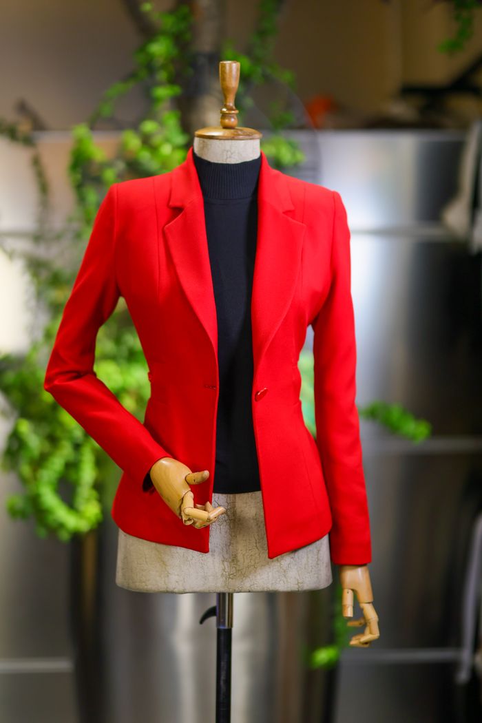 team-03 Stylish red jacket displayed on a mannequin, perfect for fashion and retail themes.